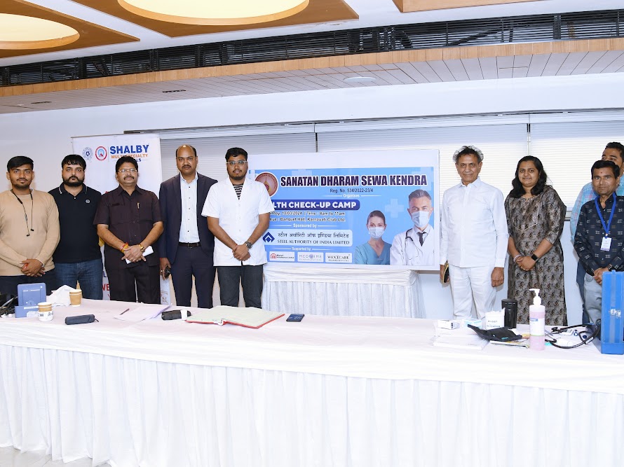 Organisers and medical team gathered around the health check-up camp banner